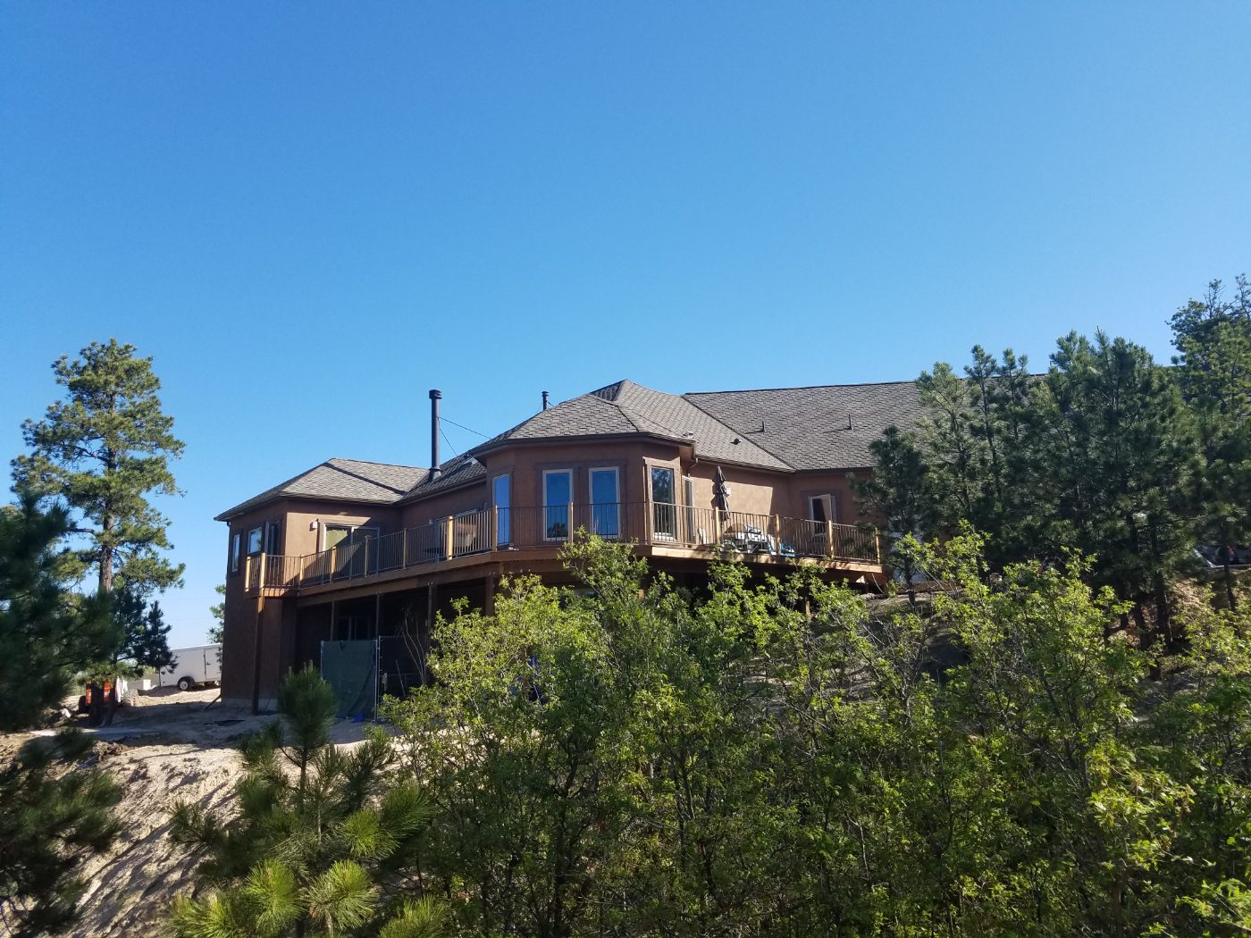 A Cornerstone custom home with a wraparound deck, set among the pines